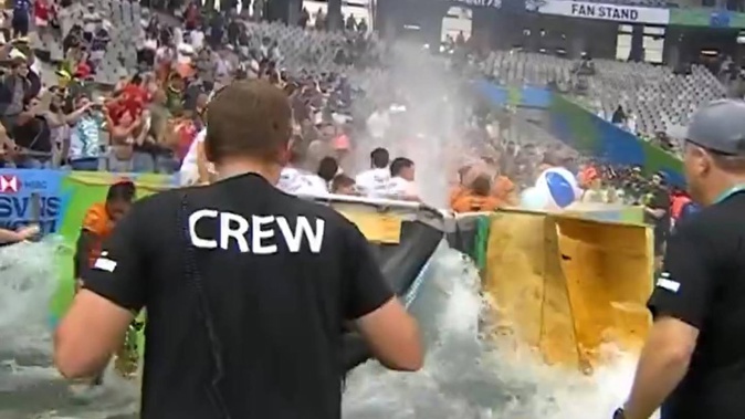 The sideline pool bursts as Australian and Argentine players celebrate their Cape Town Sevens titles. Photo / Twitter/ SVNSSeries