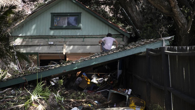 Many houses, including this one, have been red-stickered in Piha. Photo / George Heard