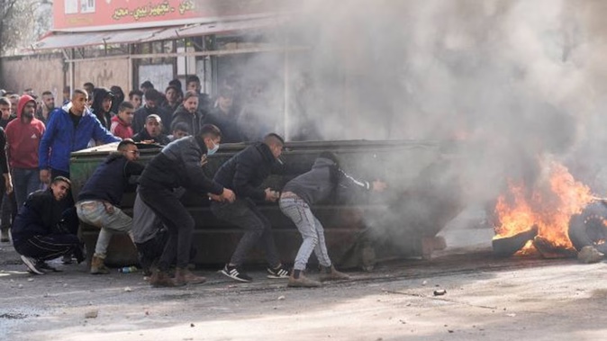 Palestinians clash with Israeli forces following an army raid in the West Bank city of Jenin on Thursday, where Israeli forces killed at least nine Palestinians in the deadliest day of violence in many years. Photo / AP
