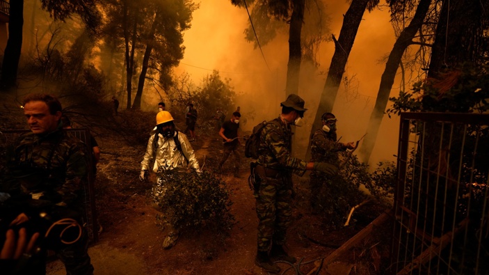 People try to extinguish the flames during a wildfire at Pefki village on Evia island, about 189 kilometers (118 miles) north of Athens, Greece, Sunday, Aug. 8, 2021. (Photo / AP)