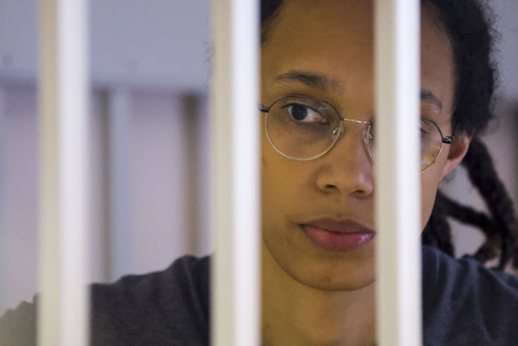 US Basketball player Brittney Griner looks through bars as she listens to the verdict standing in a cage in a courtroom in Khimki, outside Moscow, Russia. Photo / AP