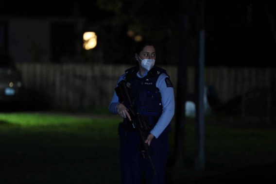 An armed police officer on Benghazi Rd in Panmure, East Auckland, following the latest gun-related incident in Auckland last night. Gunshots were heard, and one person injured. Photo / Hayden Woodward