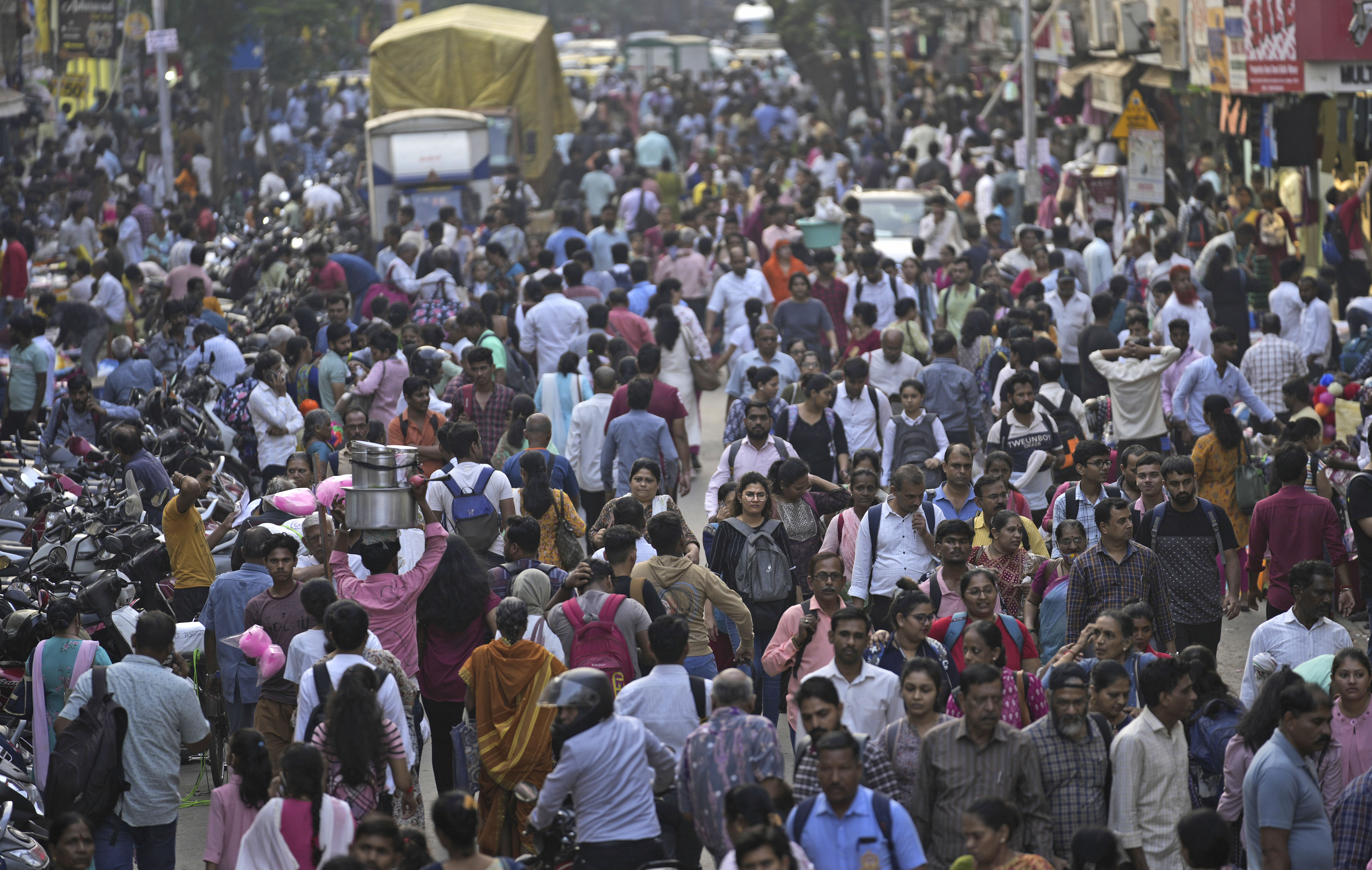 A crowd walks in a market area outside Dadar station in Mumbai, India, Friday, March 17, 2023. India will soon eclipse China to become the world's most populous country, and its economy is among the fastest-growing. But the number of Indian women in the workforce, already among the 20 lowest in the world, has been shrinking for decades. Photo / AP