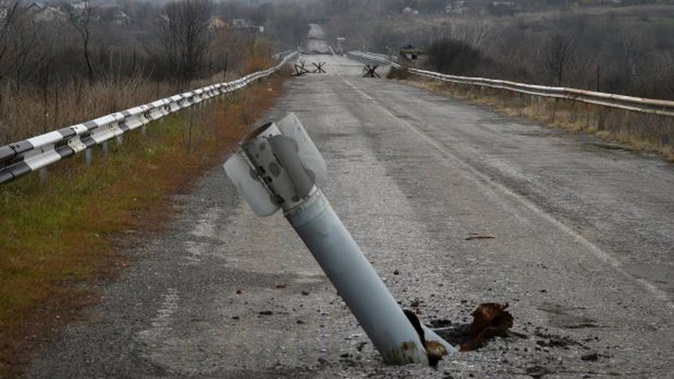 A tail of a multiple rocket sticks out of the ground near the recently recaptured village of Zakitne, Ukraine, last month. The Kremlin says it is up to Ukraine to end the war. Photo / AP