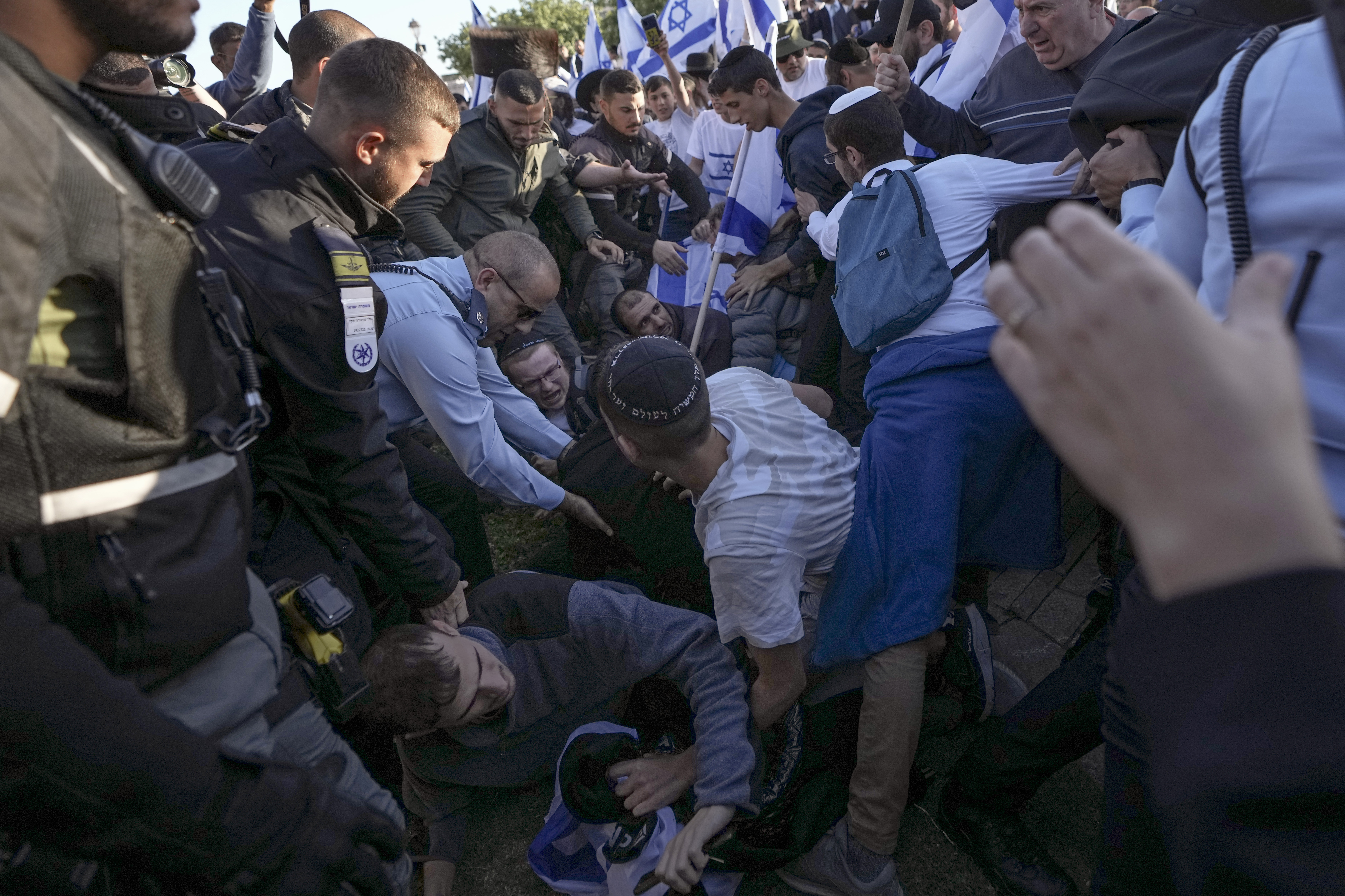 Israeli police officer block right wing activists from marching towards the Old City in Jerusalem. (Photo / AP)