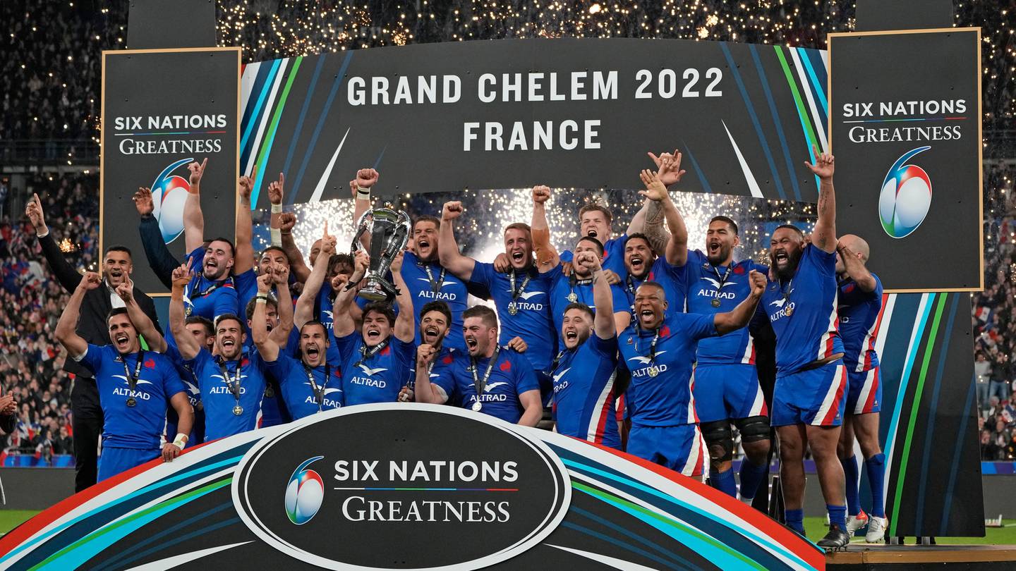 France's Antoine Dupont raises the trophy as he celebrates with teammates after winning the Six Nations. Photo / AP