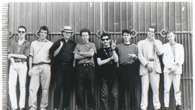 The wild antics of The Pogues' lead singer Shane MacGowan, doing the peace sign, in New Zealand are revealed in a new book. Photo / Supplied
