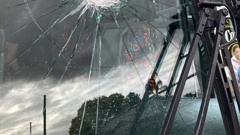 A rock came through the front window of a Tranzit bus full of schoolkids on Friday, narrowly missing the driver.
