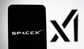 In this photo illustration, the SpaceX logo is seen on a smartphone and a xAI logo in the background. (Photo Illustration by Pavlo Gonchar/SOPA Images/LightRocket via Getty Images)