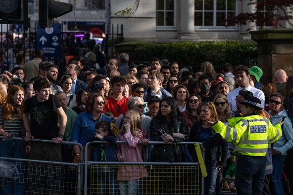 A police officer gestures as a crowd waits to cross a road near The Mall ahead of the royal coronation, on May 5, 2023 in London, England. Photo / AP