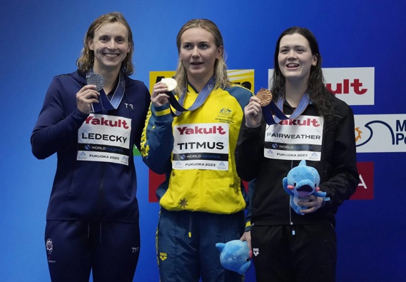 Gold medallist Ariarne Titmus of Australia, center, is flanked by silver medallist Katie Ledecky of the United States, and bronze medallist Erika Fairweather of New Zealand. Photo / AP