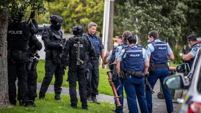Armed Police in Cliffview Road, Greenbay, following an earlier homicide near the New Haven Motel in New Lynn. (Photo / Michael Craig)