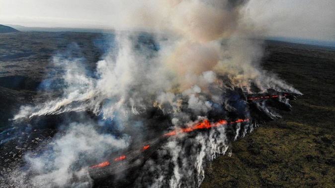 A volcanic eruption emits smoke and flowing lava south of Reykjavik, Iceland on July 10, 2023. Kristinn Magnusson/AFP/Getty Images