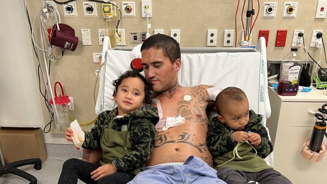 Jahden Nelson in hospital with his children Valley Rose and Kaiser. Photo / Supplied