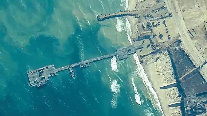 A key section of the US military-built pier designed to carry badly needed aid into Gaza by boat has been reconnected to the Gaza beach following storm damage repairs and aid will begin to flow soon, the US Central Command announced on Friday. Photo / AP