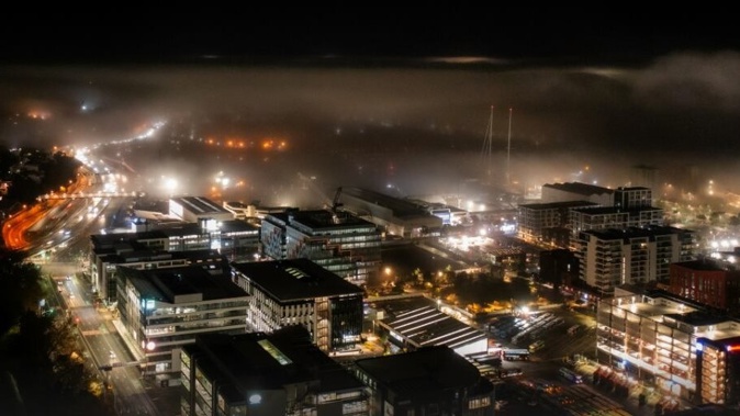 Fog in Auckland looking out to the harbour bridge from the CBD on the morning of June 10, 2025. Photo / Carson Bluck