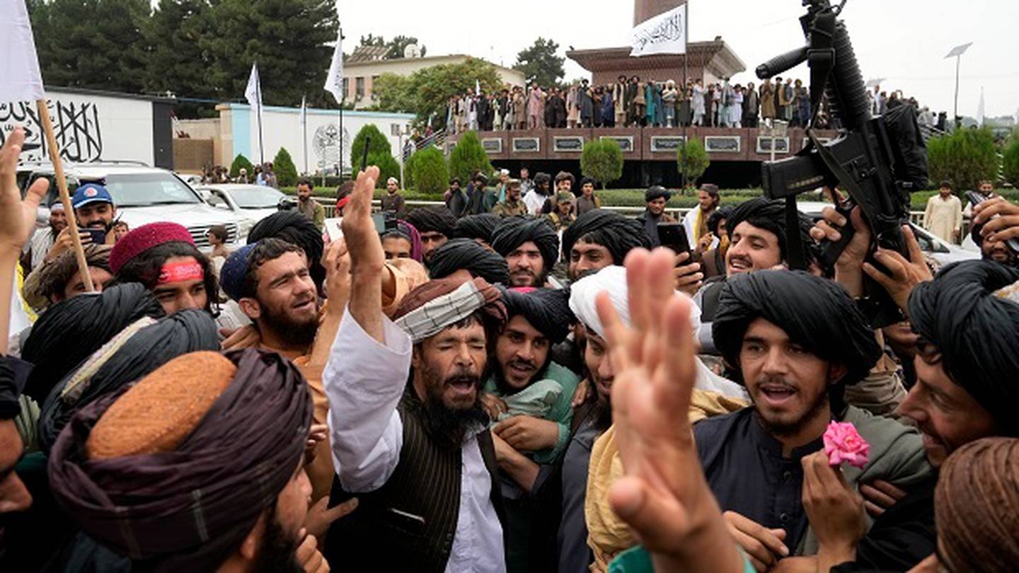 Taliban fighters celebrate one year since they seized the Afghan capital, Kabul, in front of the US Embassy. Photo / AP
