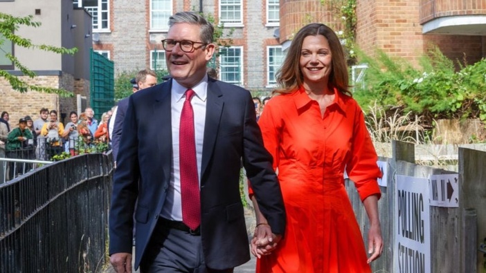 Keir Starmer, leader of the Labour Party, left, and Victoria Starmer, his wife, arrive to cast their votes in the general election, in London, UK. Photo / Getty Images
