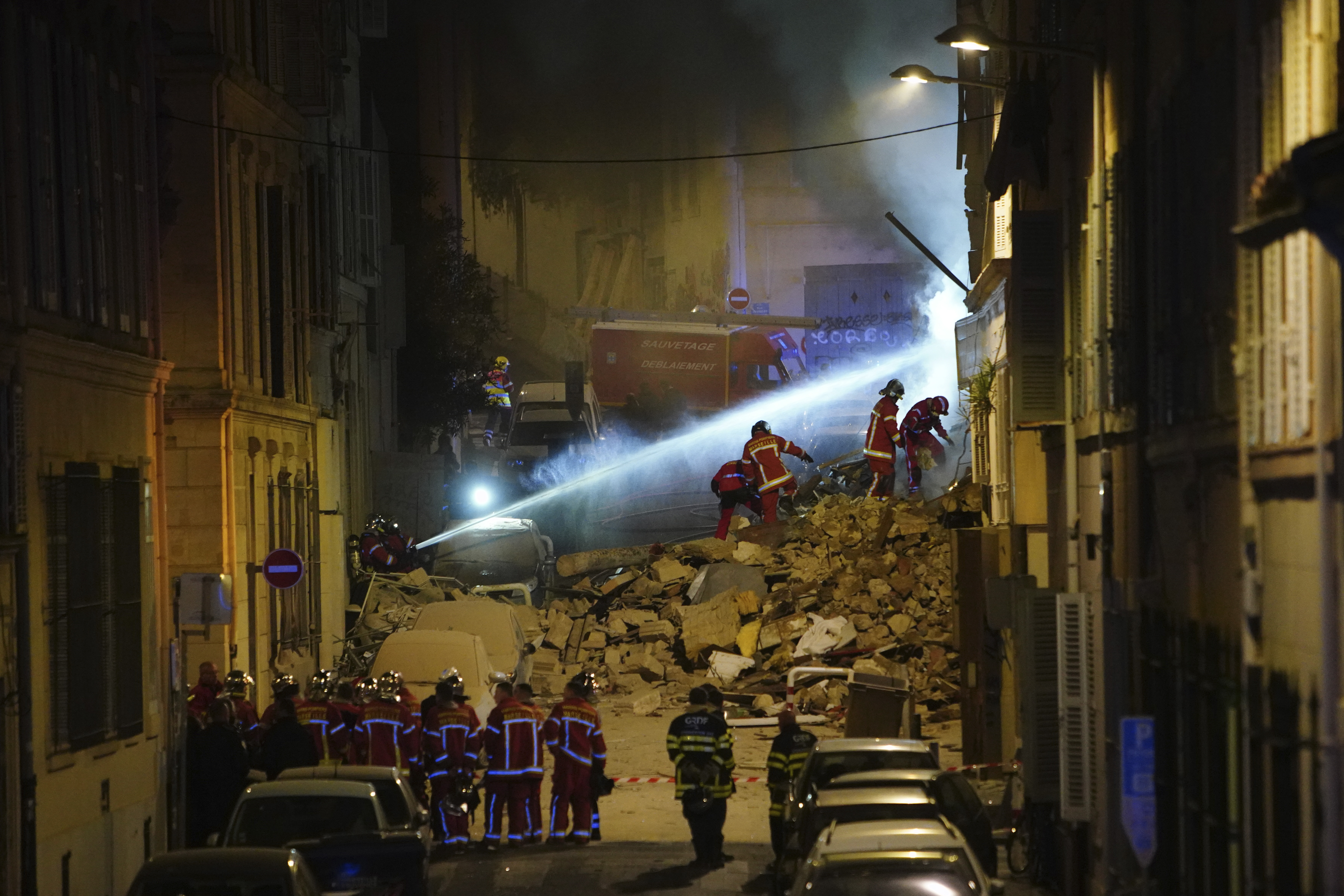 Firefighters work after building collapsed early Sunday, April 9, 2023 in Marseille, southern France. A residential building in France's port city of Marseille collapsed in a loud explosion early Sunday followed by a fire deep within the rubble that hindered rescue efforts. Photo / AP