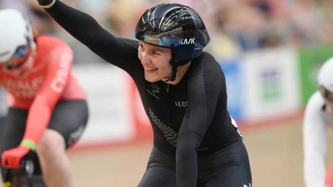 Ellesse Andrews waves to her supporters after claiming her fourth medal of the Commonwealth Games. Photo / Photosport