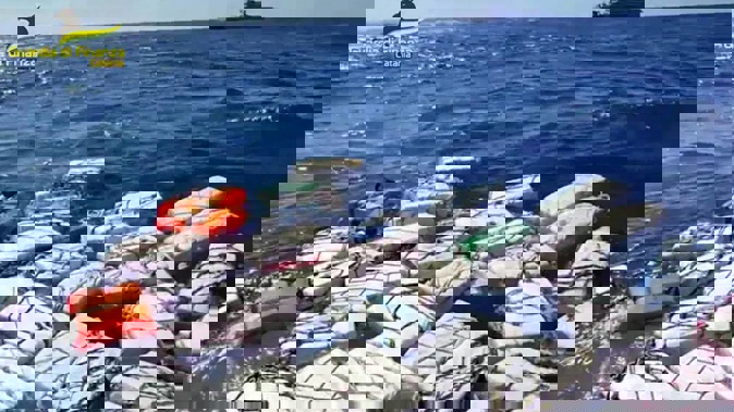 Boxes containing cocaine float in the Sicilian Strait off Catania. Photo / AP