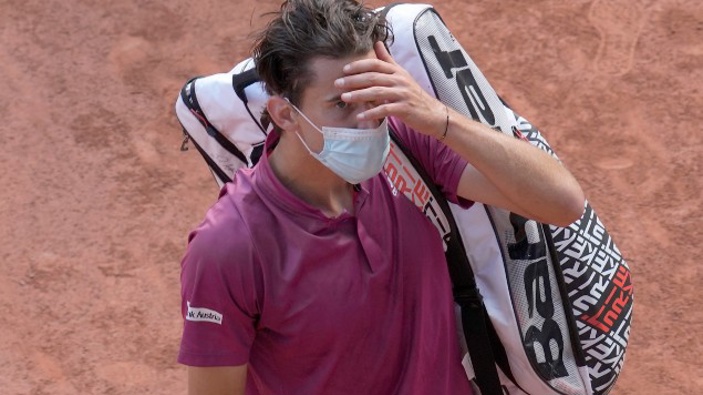 Austria's Dominic Thiem walks off the court after losing to Spain's Pablo Andujar in their first round match of the French Open tennis tournament. (Photo / AP)