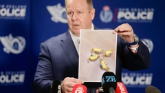 Detective Inspector Glenn Baldwin holds up a photo of the Rinda-branded meth-laced lollies found in food parcels given to needy families. Photo / Alex Burton