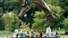 Beer cans are left as tributes at the base of the Shane Warne statue outside the Melbourne Cricket Ground. (Photo / Getty)