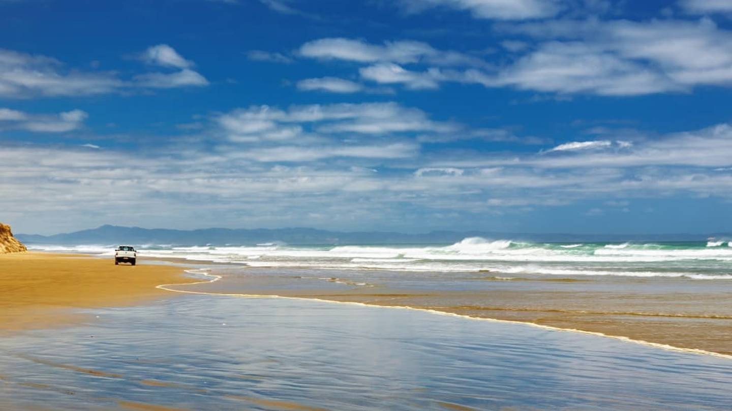 A car on Te Oneroa-a-Tōhe Ninety Mile Beach. Photo / RNZ, 123rf
