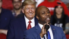 Senator Tim Scott speaks in front of former President Donald Trump during a campaign rally in 2020. Photo / AP