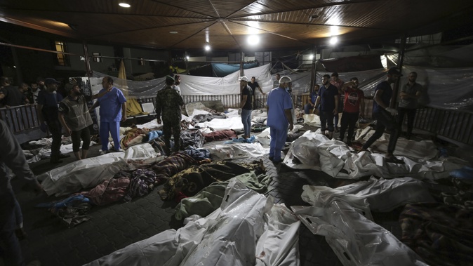 Bodies of Palestinians killed by an Israeli airstrike that hit the Ahli Arab hospital are seen gathered at the front yard of the al-Shifa hospital, in Gaza City, central Gaza Strip, Tuesday, Oct. 17, 2023. Photo / AP