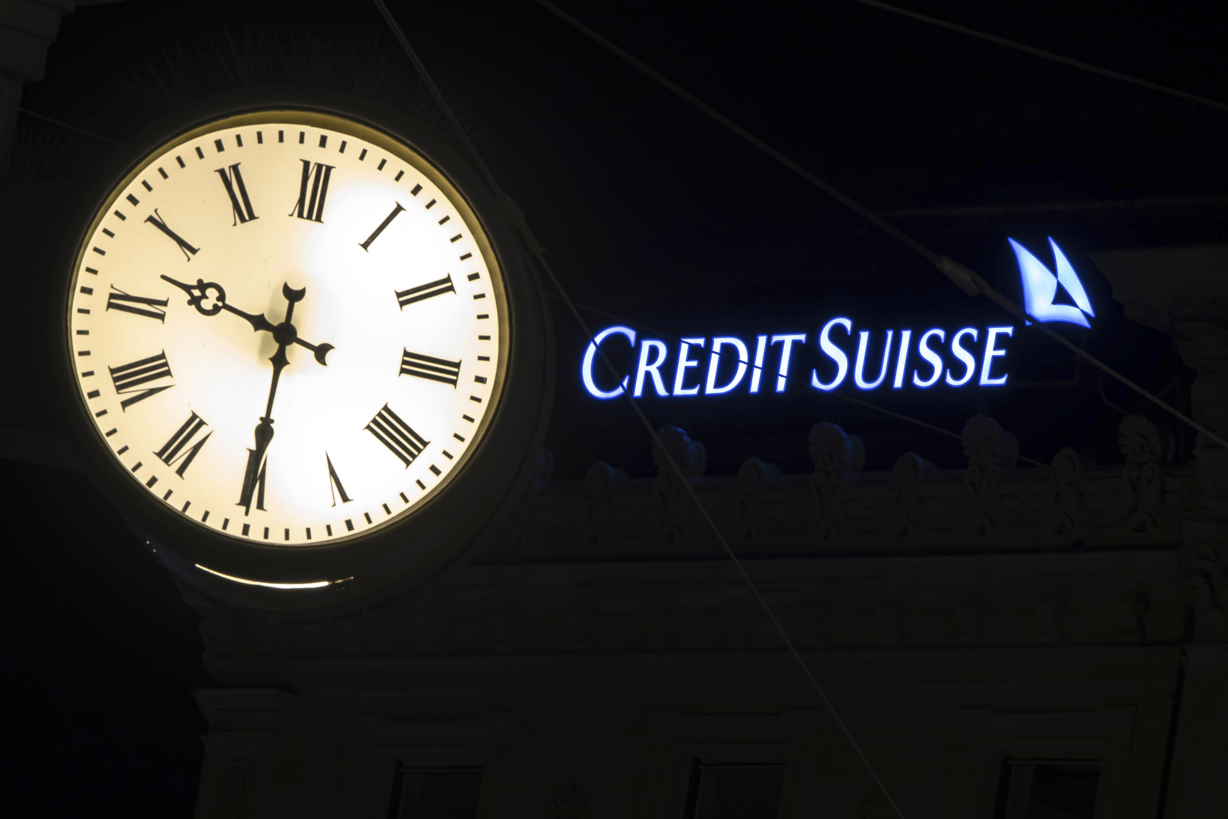 The illuminated logo of Swiss bank Credit Suisse is seen behind a clock at the banks headquarters at Paradeplatz in Zurich, Switzerland on Saturday, March 18, 2023. Photo / AP