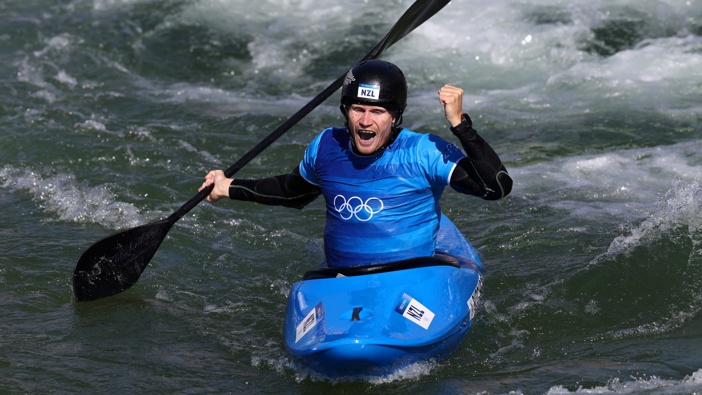 Finn Butcher celebrates crossing the finish line first and claiming gold in the men's canoe slalom cross at the Paris Olympics. Photo / Photosport