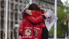 Infected blood campaigners hug during a gathering at Parliament Square, ahead of the publication of the final report into the scandal, in London, Sunday, May 19, 2024. Photo / AP
