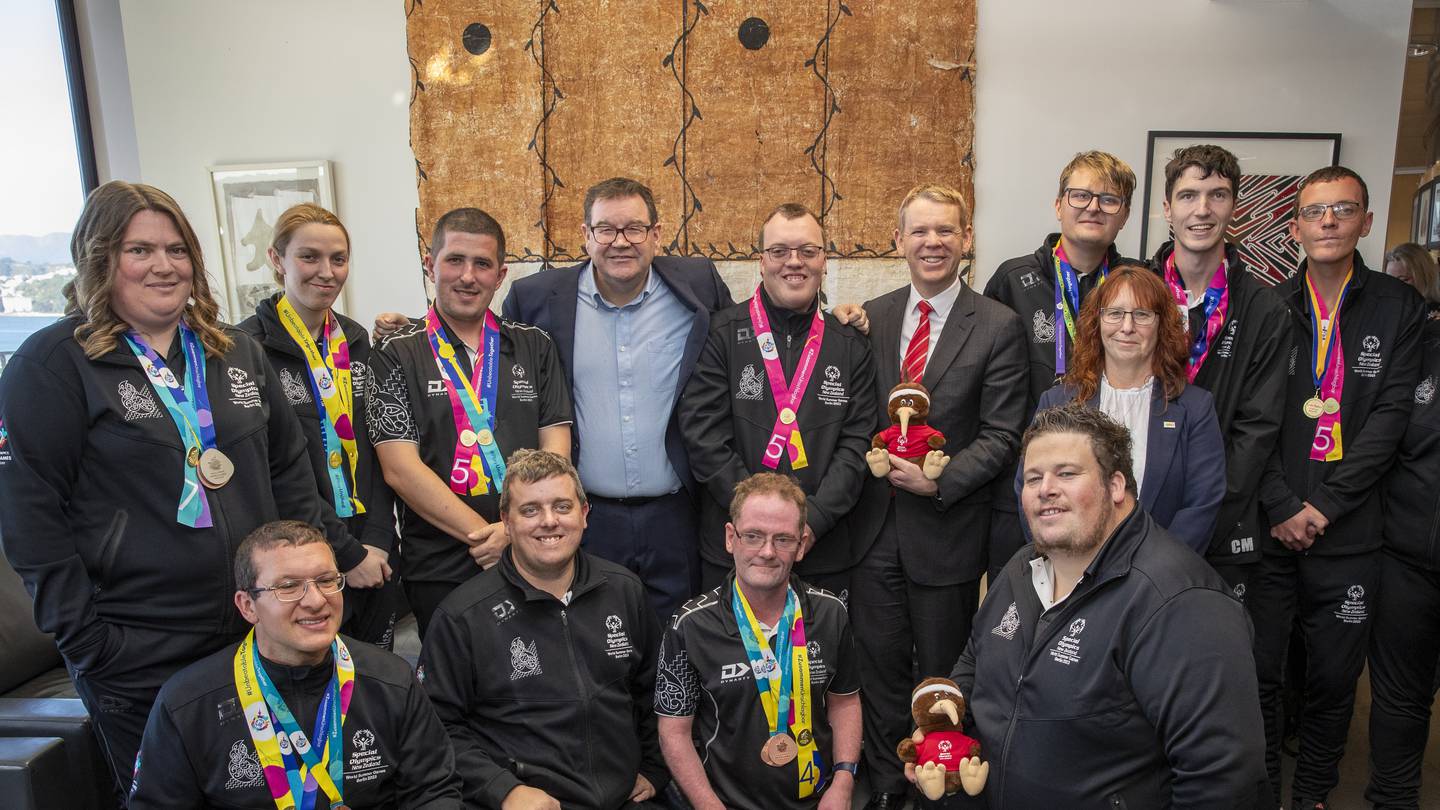 Prime Minister Chris Hipkins, Sports Minister Grant Robertson and Act MP Toni Severin with NZ’s record-breaking Special Olympians on the Beehive's 9th floor. Photo / Mark Mitchell