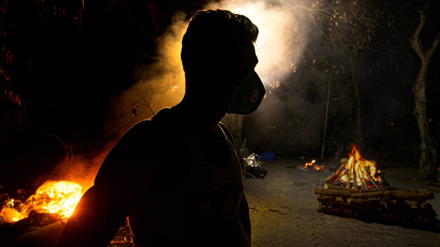 Ramananda Sarkar, 43, who has cremated more than 450 Covid-19 victims, stands by funeral pyres in Gauhati, India in September 2020. (Photo / AP)