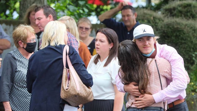 Family and friends of the victims, together with sole survivor Mitchell Kay, catch up outside the High Court at Hamilton after sentencing this afternoon. (Photo / Mike Scott)