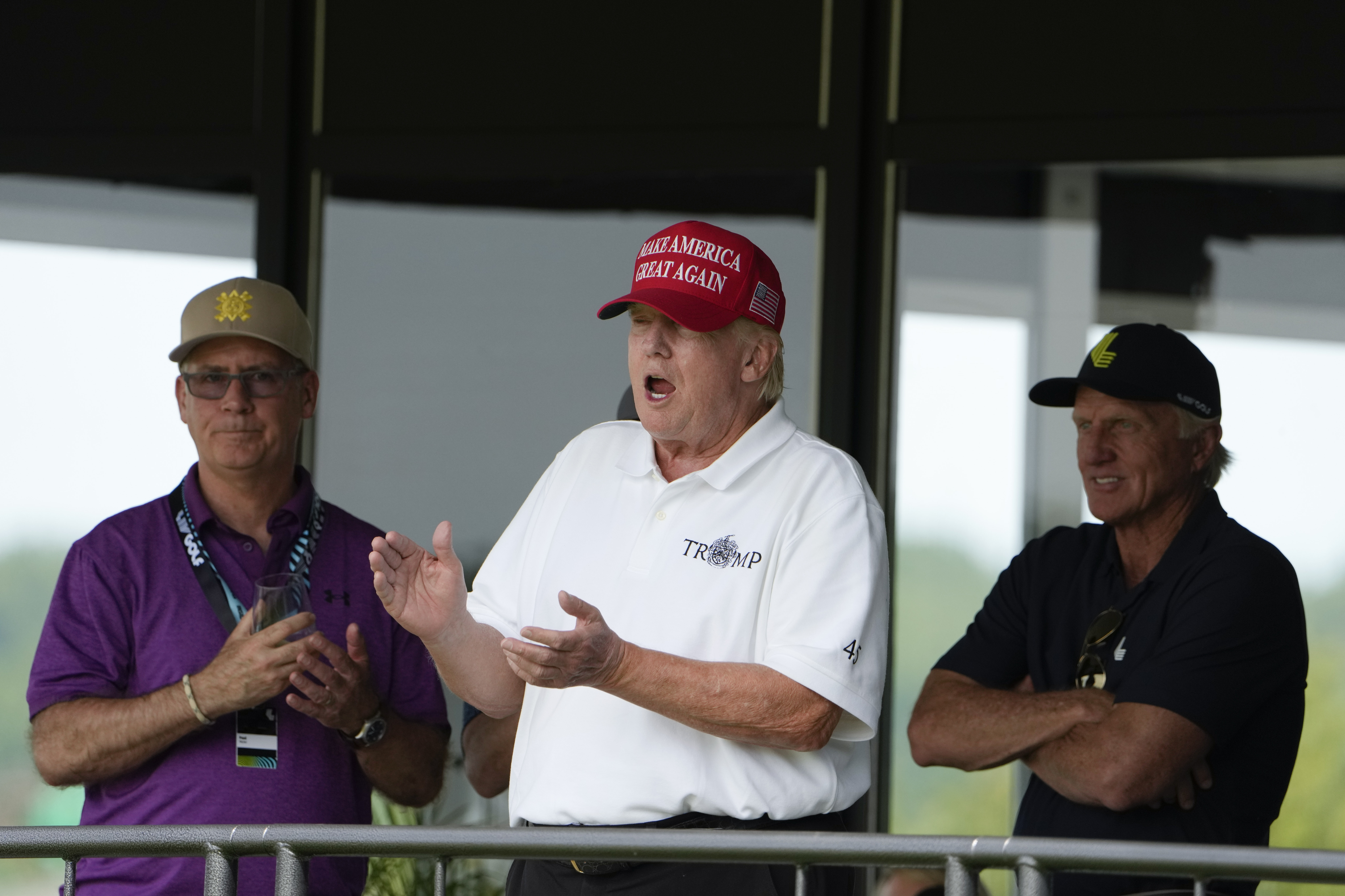 Former President Donald Trump, Greg Norman, LIV Golf CEO, right, and Paul Myler, deputy head of mission for the Australian Embassy in Washington, left, watch the second round of the LIV Golf at Trump National Golf Club, Saturday, May 27, 2023, in Sterling, Va. Photo / AP