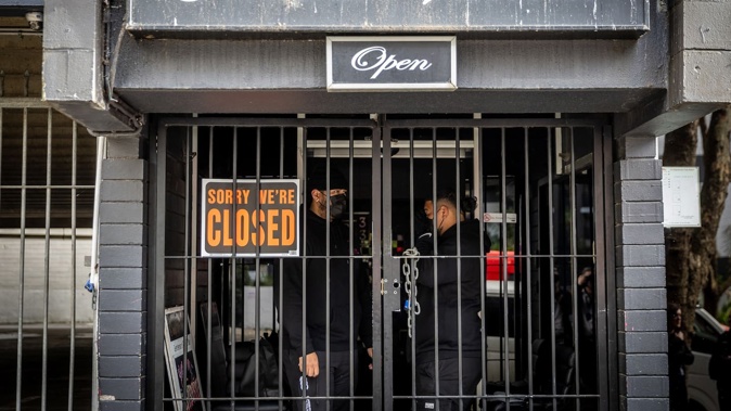 Security guards stand at the entrance to the closed down One33 brothel at 133 Vincent St in Auckland's city centre. Photo / Michael Craig