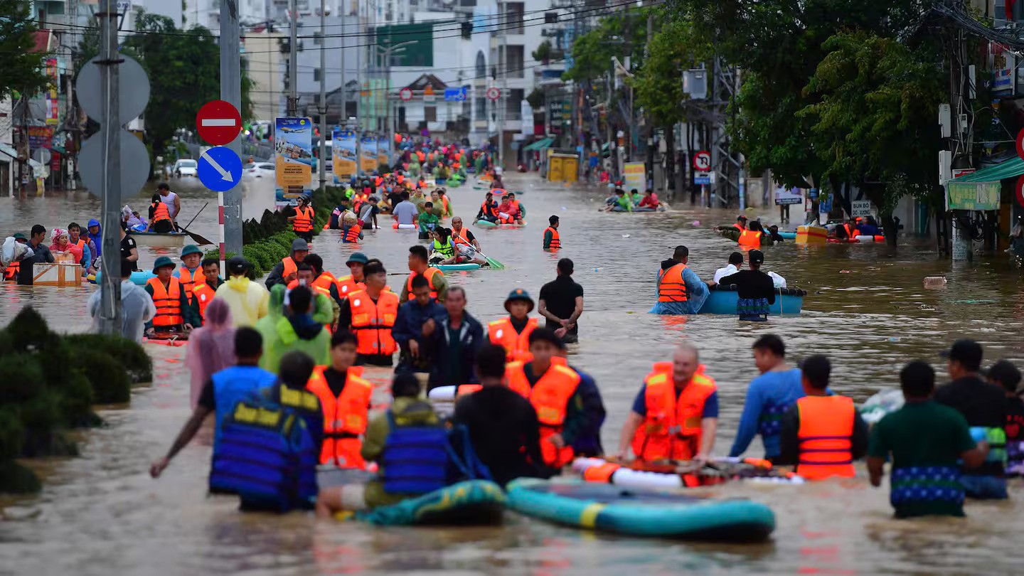 This photo taken on November 20, 2025 shows people wading through floodwaters in Nha Trang in Vietnam's coastal province of Khanh Hoa. Rescuers raced to find more than a dozen people still missing after a week of heavy flooding in Vietnam, where authorities said at least 55 people have died. Photo / Duc Thao, AFP
