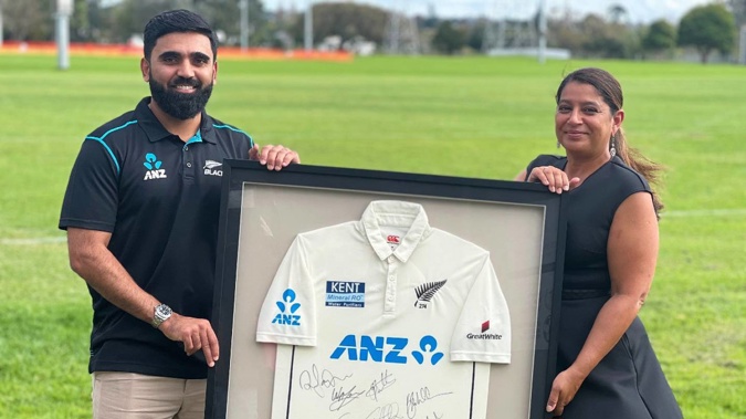 Ajaz Patel and his wife hold the jersey they are auctioning in support of Starship Hospital. (Photo / TradeMe)