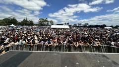 The crowds at Waitangi@Waititi 2024 in Parrs Park, Oratia, just after 1pm. Photo / Joseph Los'e
