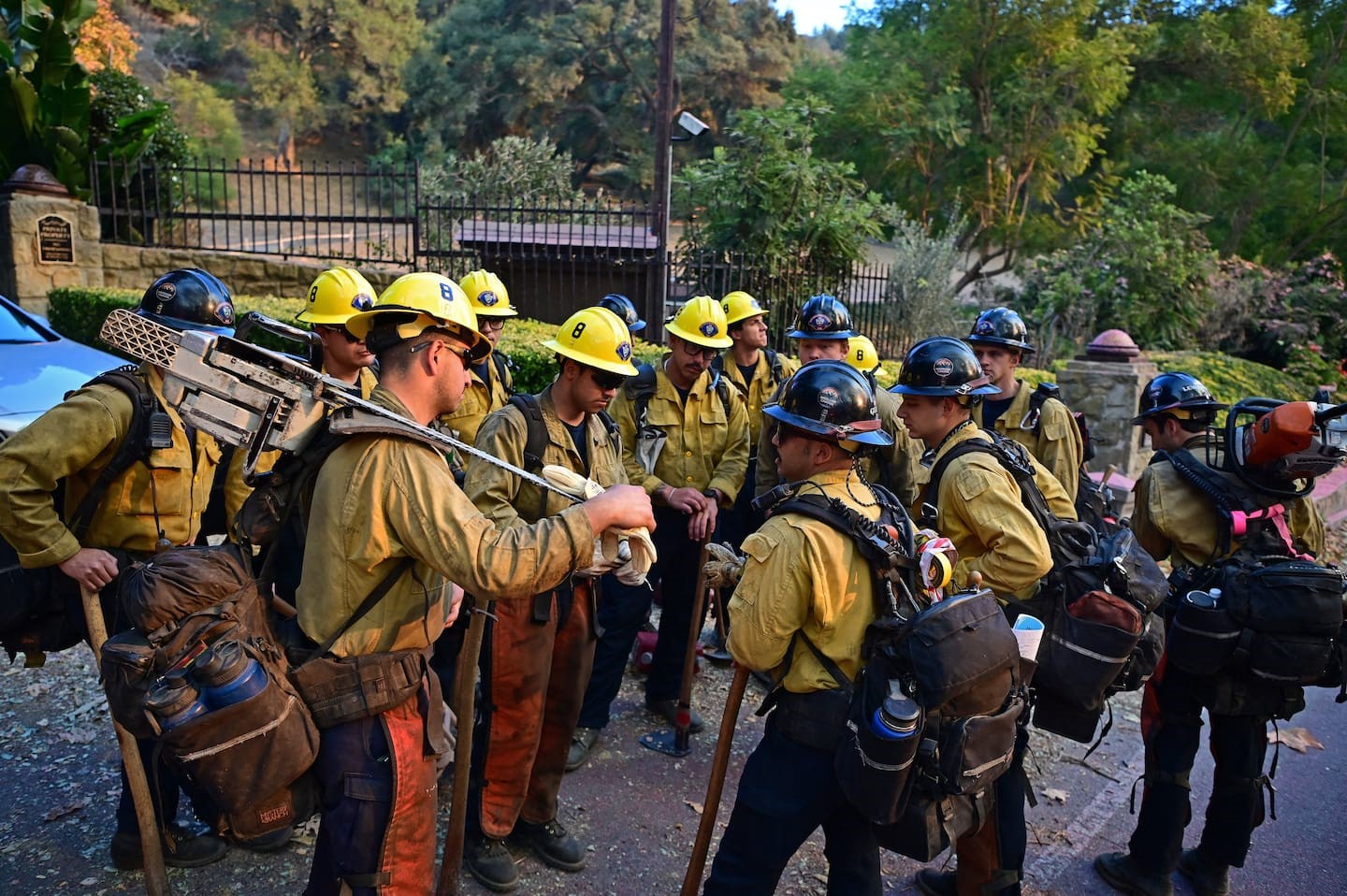 Firefighters work in the Mandeville Canyon neighbourhood of Los Angeles. Photo / AFP