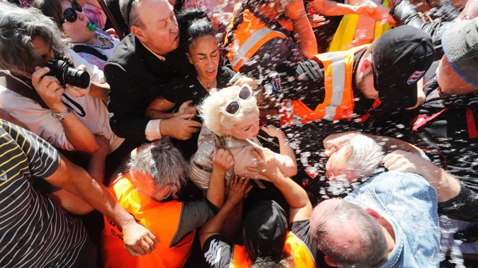 British activist Kellie-Jay Keen-Minshull, aka Posie Parker, is escorted from Albert Park. Photo / Dean Purcell