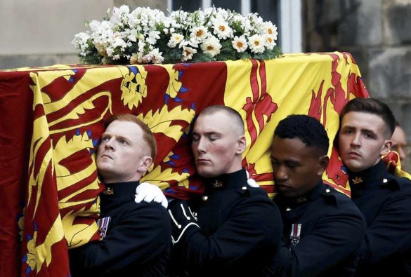 Pallbearers carry the coffin of Queen Elizabeth II, draped with the Royal Standard of Scotland, as it arrives at Holyroodhouse. Photo / Alkis Konstantinidis via AP