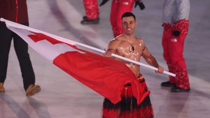 Flag bearer Pita Taufatofua of Tonga leads the team as they parade around the arena at the XXIII Olympic Winter Games in South Korea in 2018. Photo / Getty Images