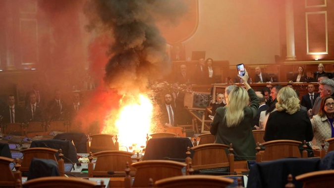 Democratic lawmakers throw a flare during a parliament session. Photo / AP