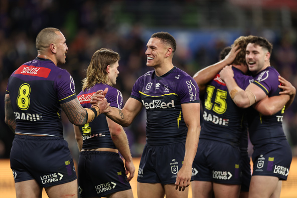 Will Warbrick of the Storm celebrates with team mates after winning the NRL Preliminary Final match between the Melbourne Storm and Sydney Roosters at AAMI Park on September 27, 2024 in Melbourne, Australia. (Photo by Cameron Spencer/Getty Images)