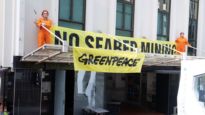 Greenpeace activists are occupying the Wellington offices of mining industry lobbyist Straterra to protest plans to Fast Track its client Trans-Tasman Resources' seabed mining in the South Taranaki Bight. A banner on the building reads No Seabed Mining. Photo / Marty Melville / Greenpeace