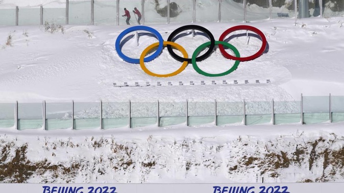 Biathletes skate above the Olympic rings during practice at the 2022 Winter Olympics. Photo / AP